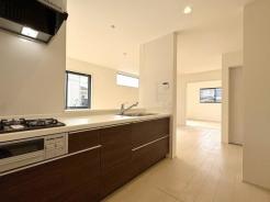 キッチン　家事をしながらコミュニケーションが取れる対面式キッチンは落ち着いた色でまとめられています。

